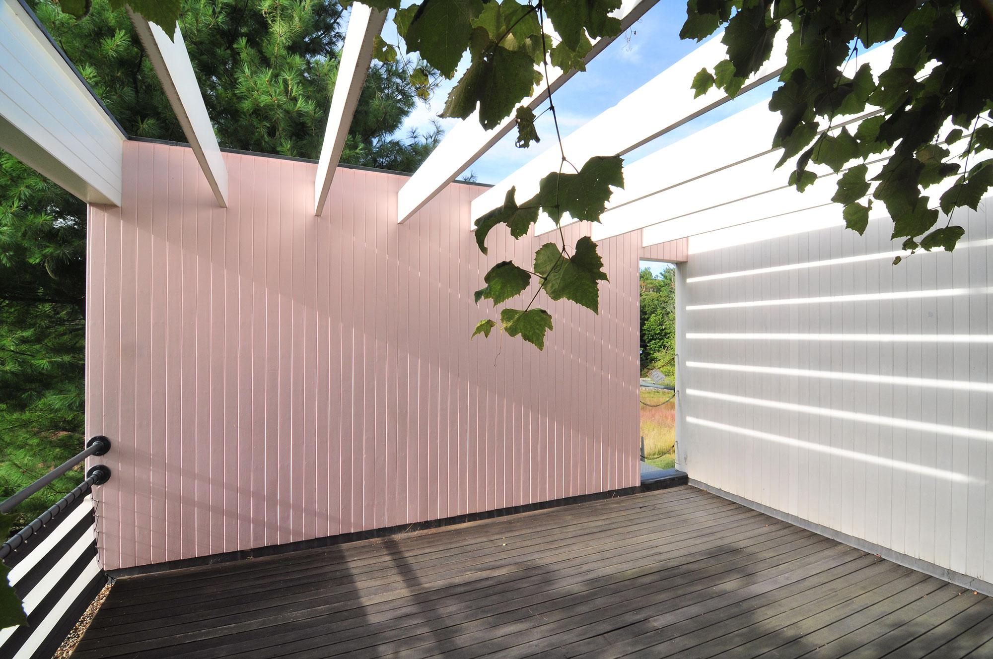 roof deck of home with exposed beam trellis